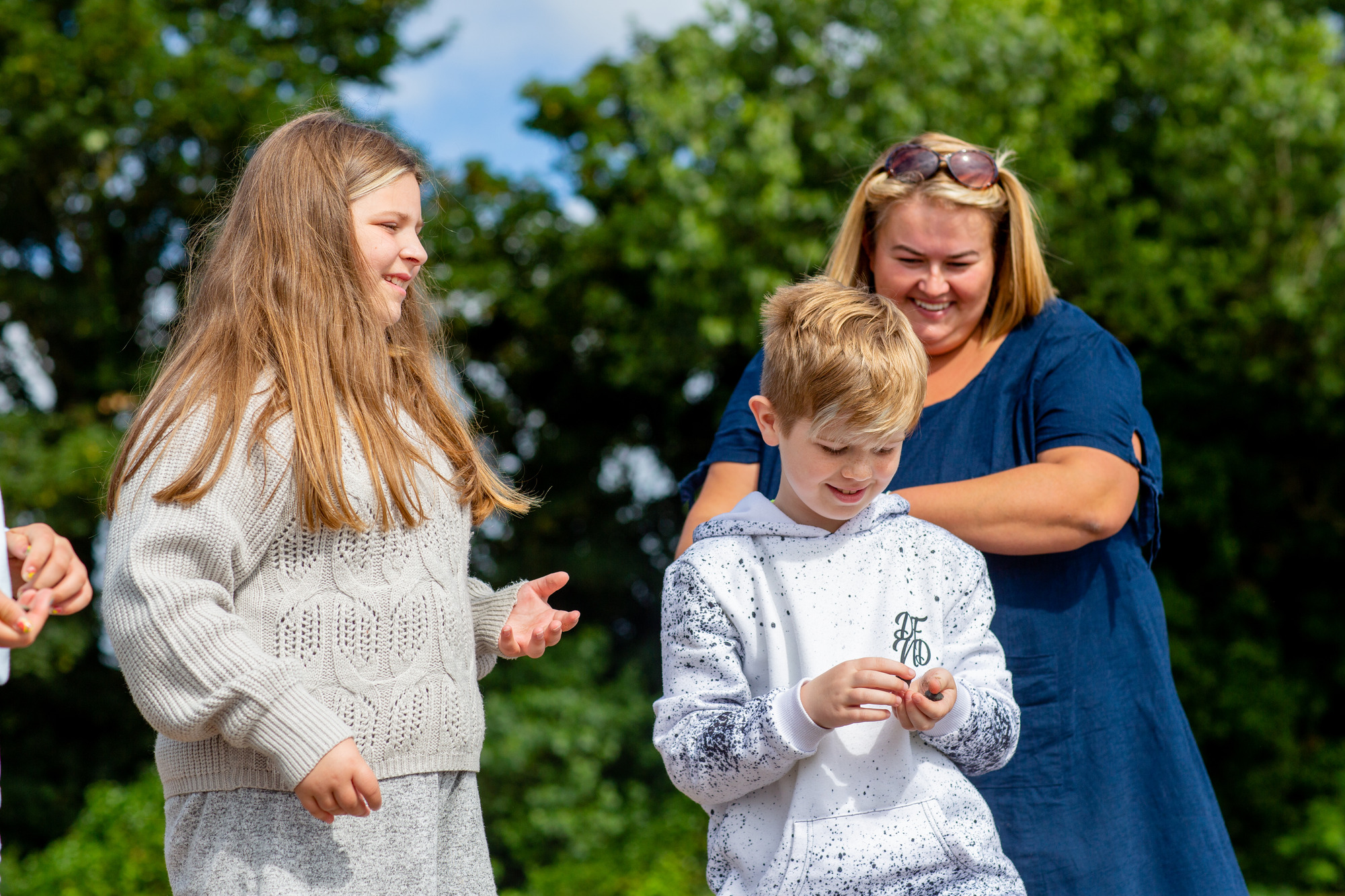 woman and two children laughing