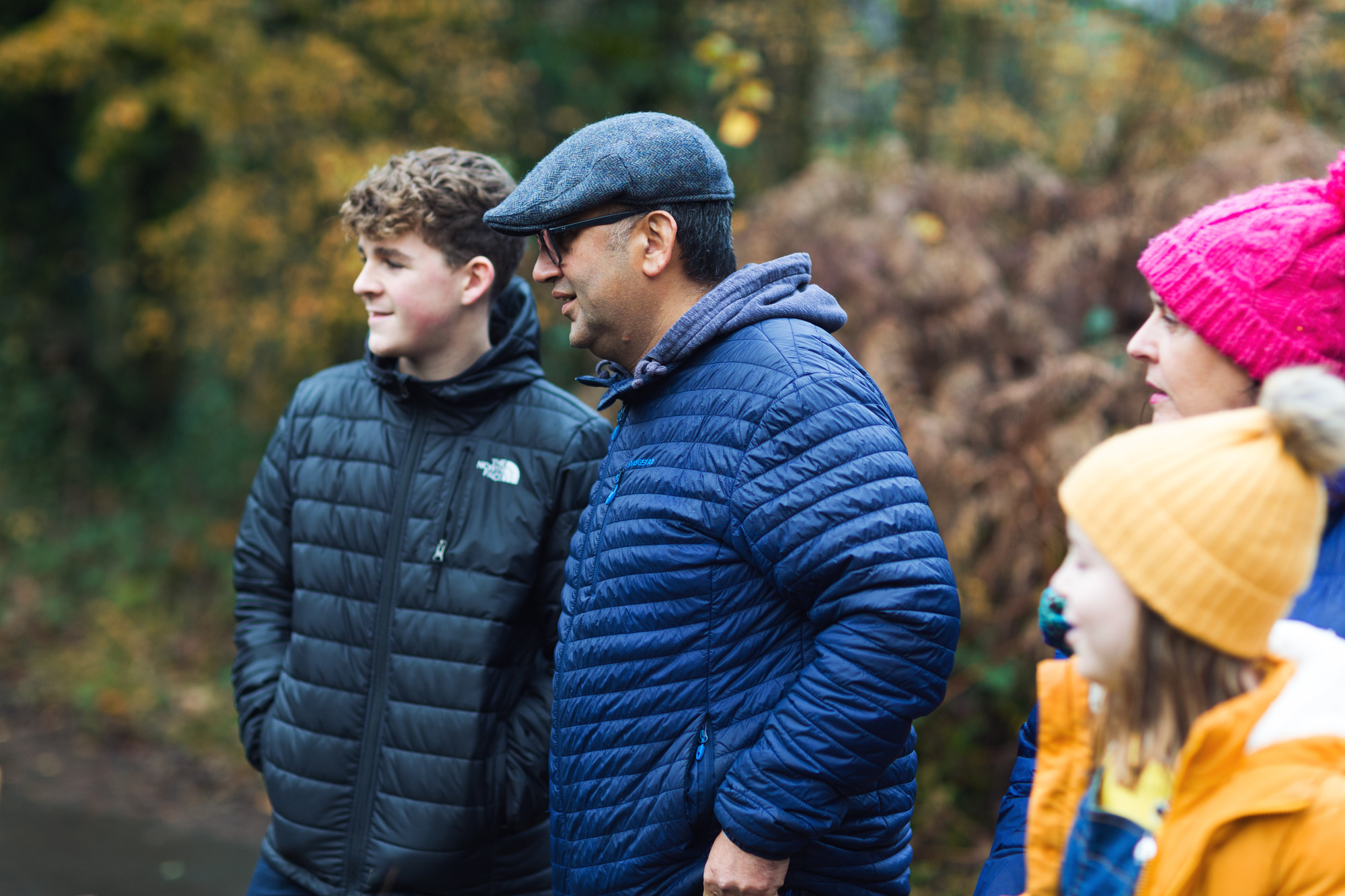 family peering off into the woods