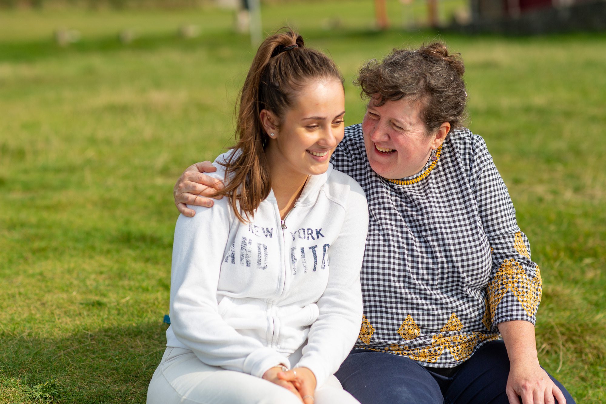 foster carer hugging young woman